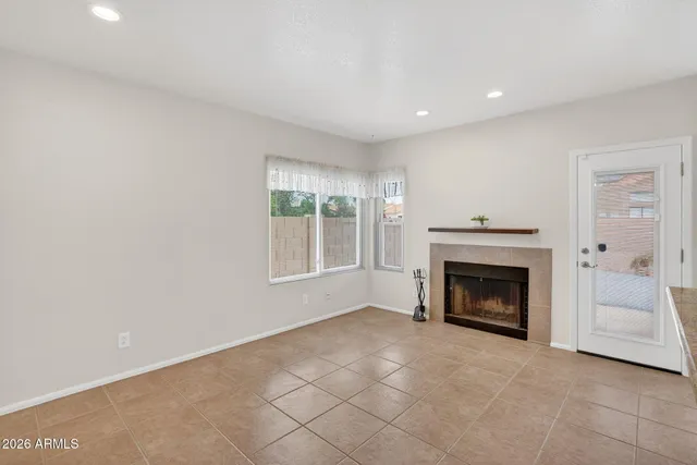 an empty room with fan and windows