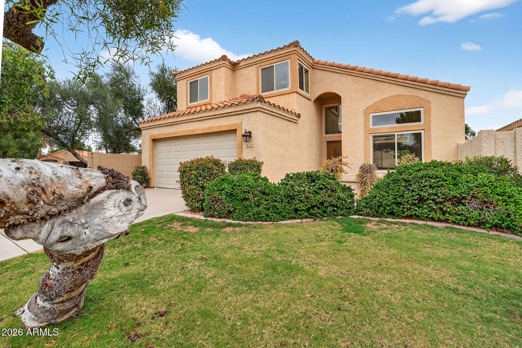 310 East Vaughn Avenue Gilbert, AZ 85234 - Photo 2 of 73 a front view of a house with a yard