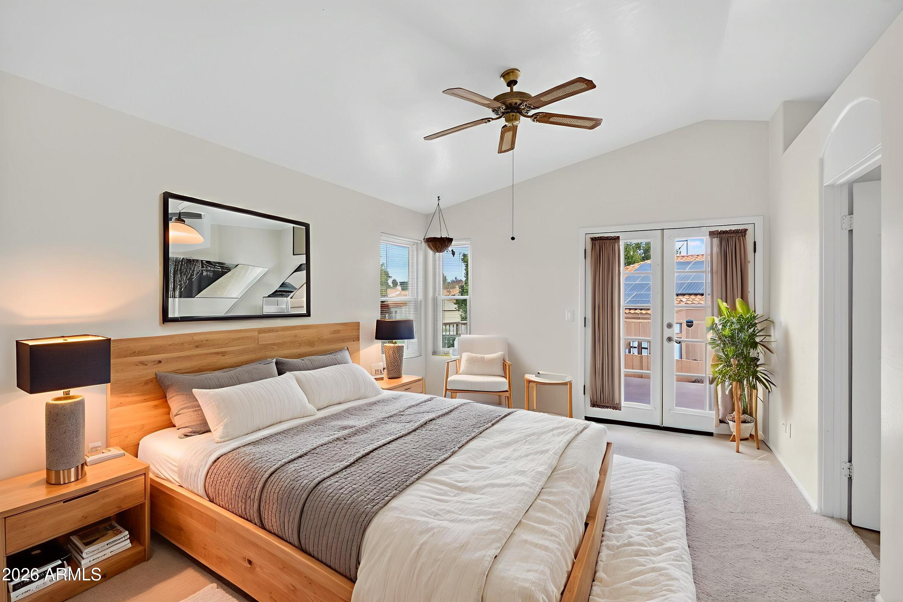 310 East Vaughn Avenue Gilbert, AZ 85234 - Photo 31 of 73 a bedroom with a large bed and a chandelier