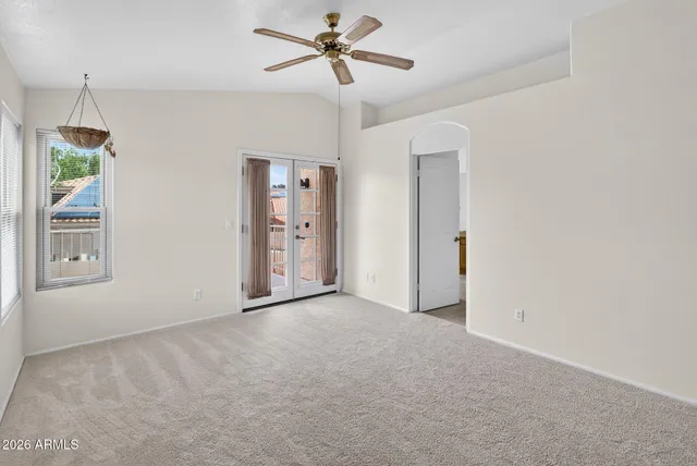 a view of a livingroom with a ceiling fan and window
