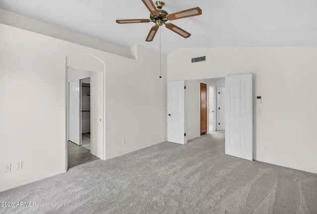 a bedroom with a bed and a painting on the wall