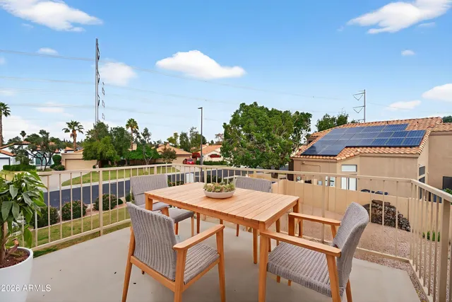 a view of a patio with table and chairs and potted plants