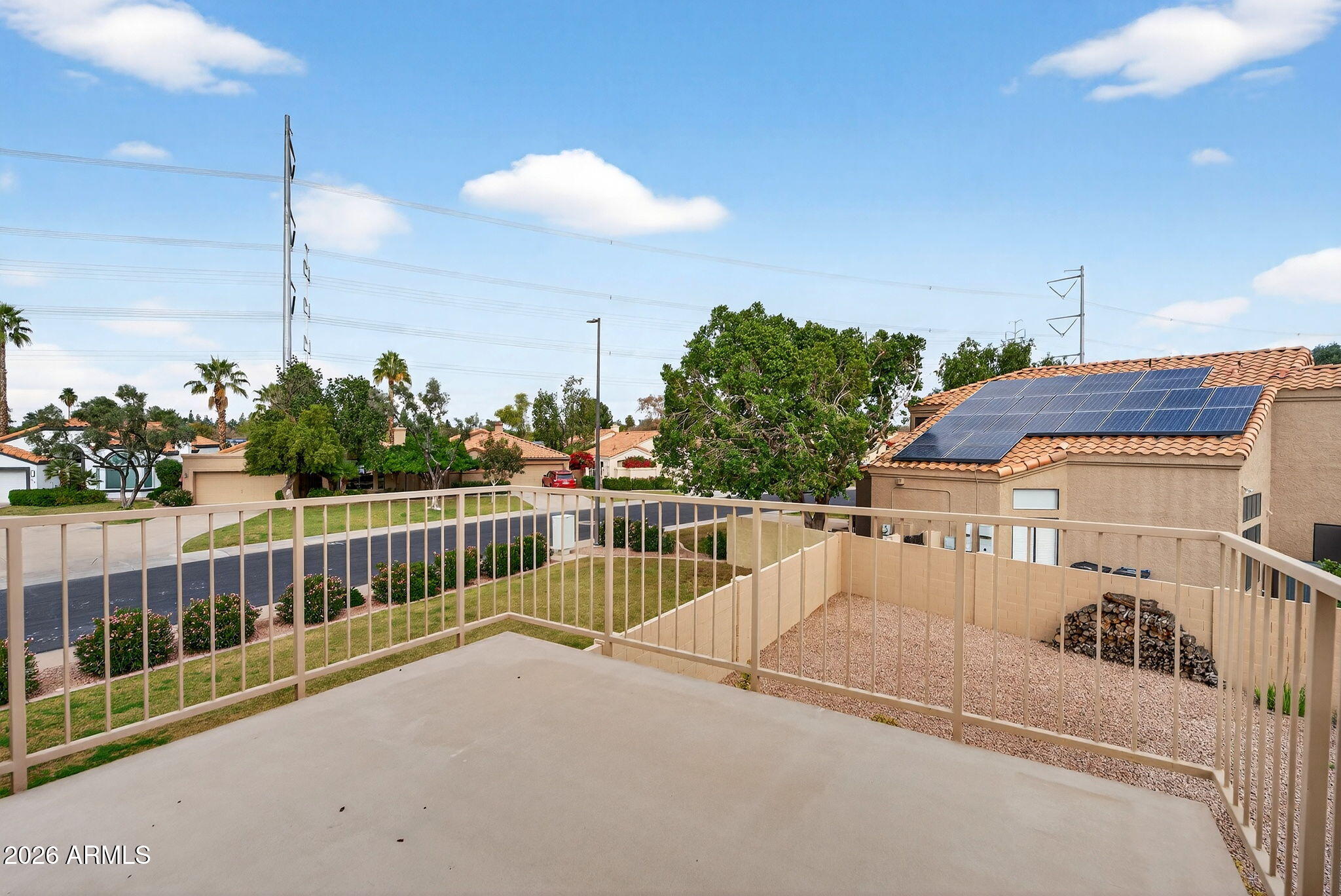 310 East Vaughn Avenue Gilbert, AZ 85234 - Photo 40 of 73 a view of a balcony with a floor to ceiling window and wooden fence
