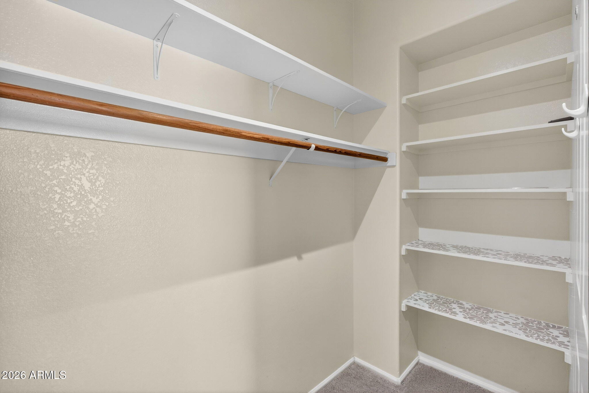 310 East Vaughn Avenue Gilbert, AZ 85234 - Photo 46 of 73 a view of walk in closet with empty racks