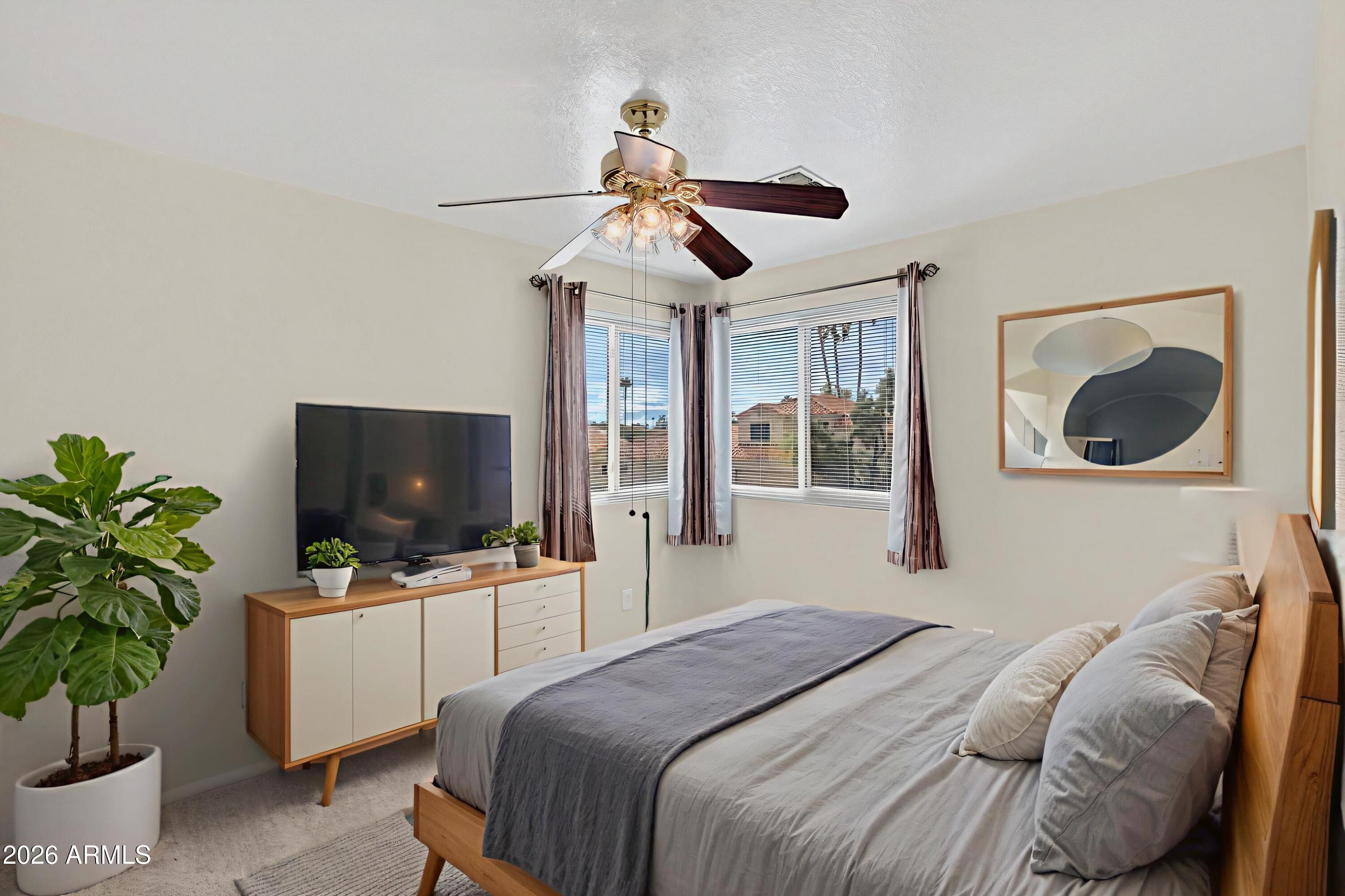 310 East Vaughn Avenue Gilbert, AZ 85234 - Photo 47 of 73 a bedroom with a bed and a flat screen tv