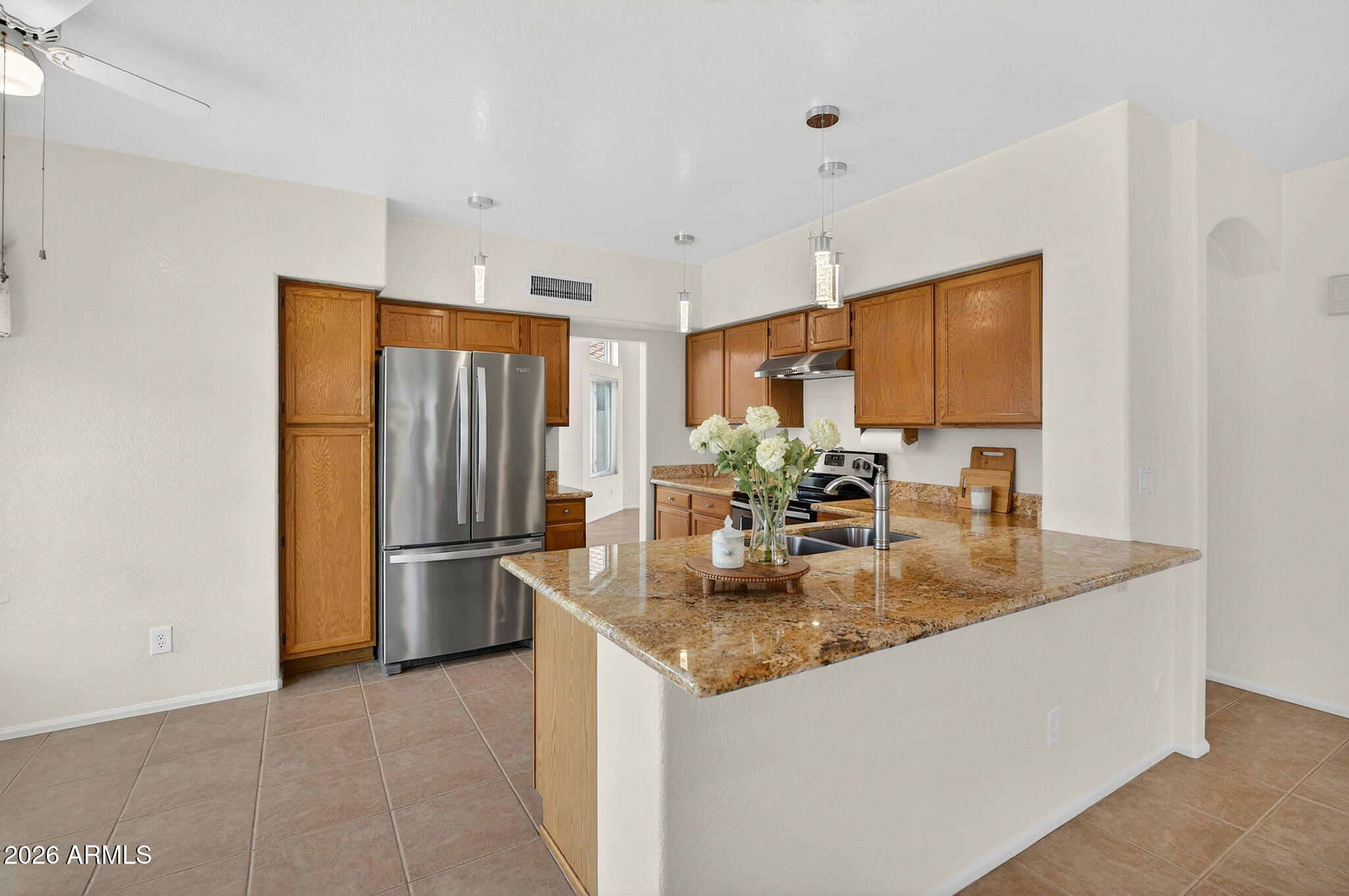 310 East Vaughn Avenue Gilbert, AZ 85234 - Photo 3 of 73 a kitchen with stainless steel appliances granite countertop a sink a refrigerator and a granite counter tops