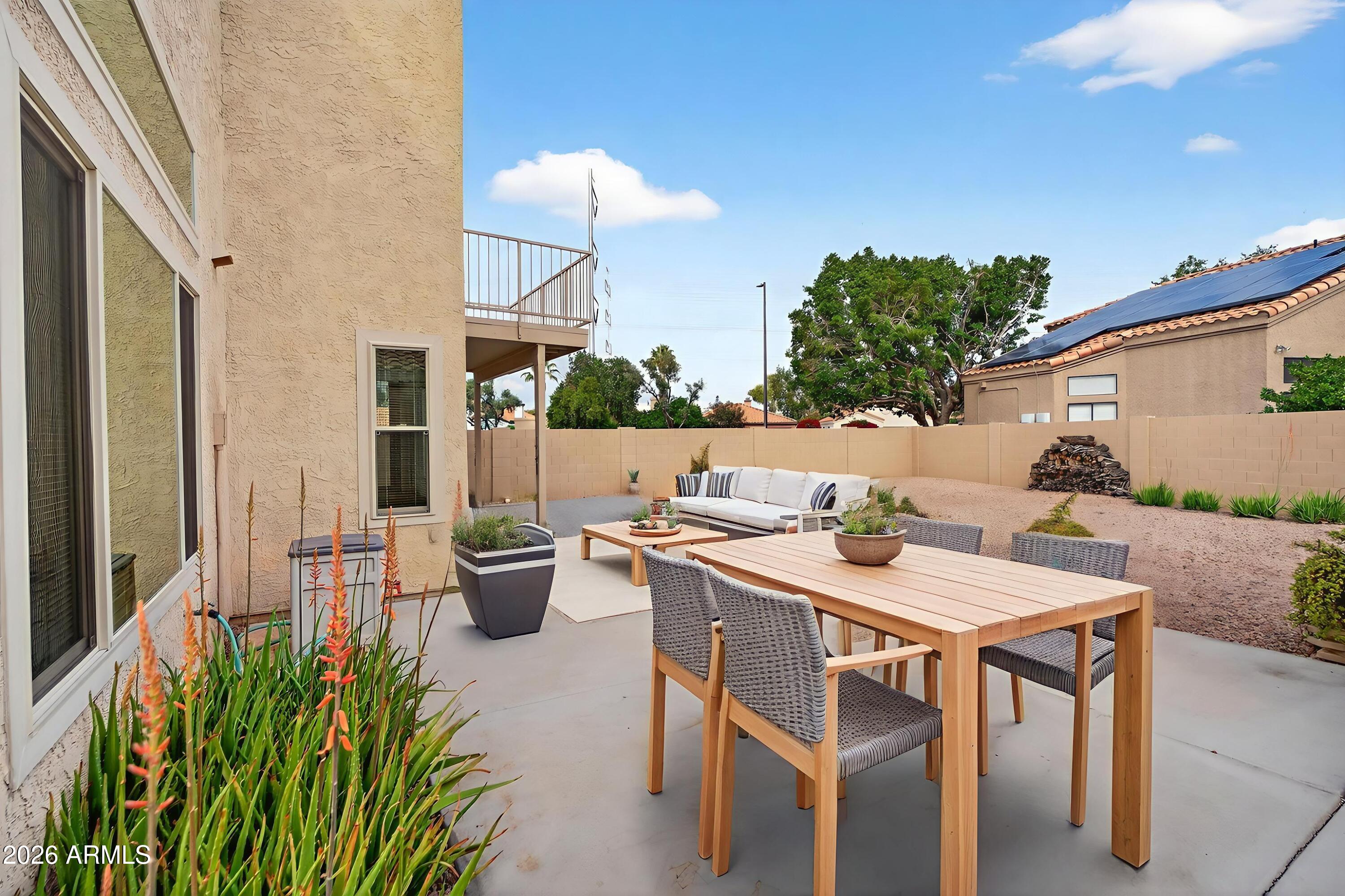 310 East Vaughn Avenue Gilbert, AZ 85234 - Photo 55 of 73 a view of a patio with table and chairs and potted plants