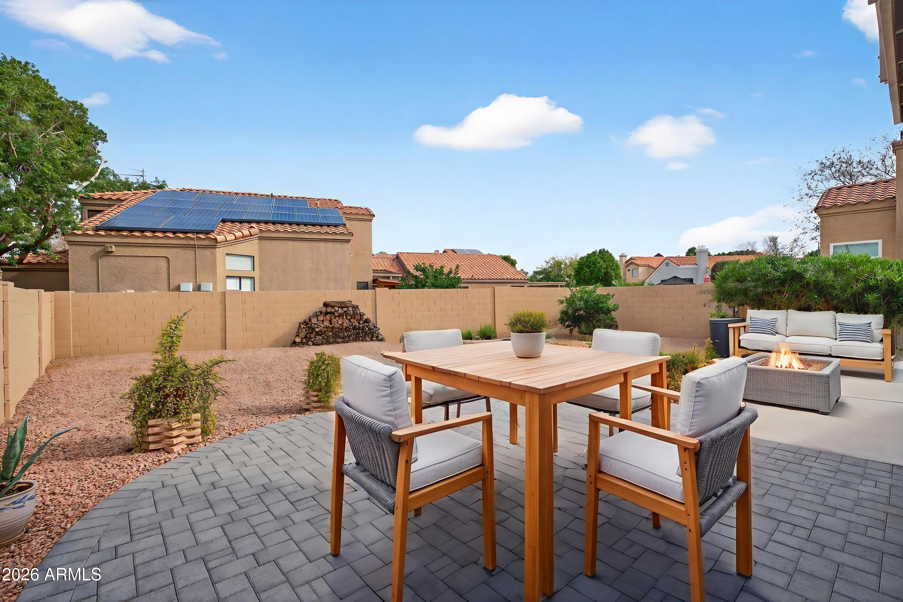 310 East Vaughn Avenue Gilbert, AZ 85234 - Photo 57 of 73 a patio with a table and chairs and potted plants
