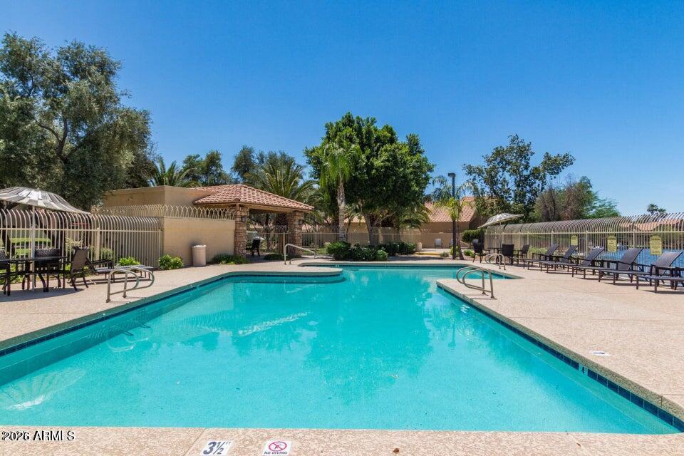 310 East Vaughn Avenue Gilbert, AZ 85234 - Photo 66 of 73 a view of a house with swimming pool and sitting area