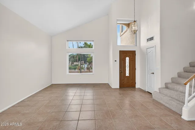 an empty room with entrance and windows