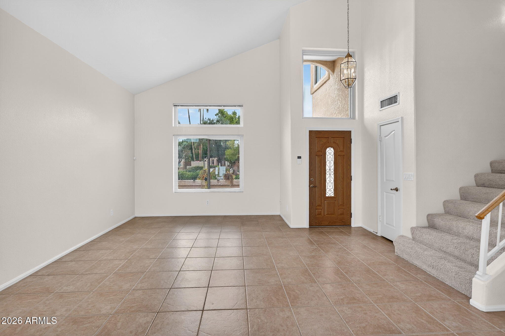 310 East Vaughn Avenue Gilbert, AZ 85234 - Photo 5 of 73 an empty room with entrance and windows