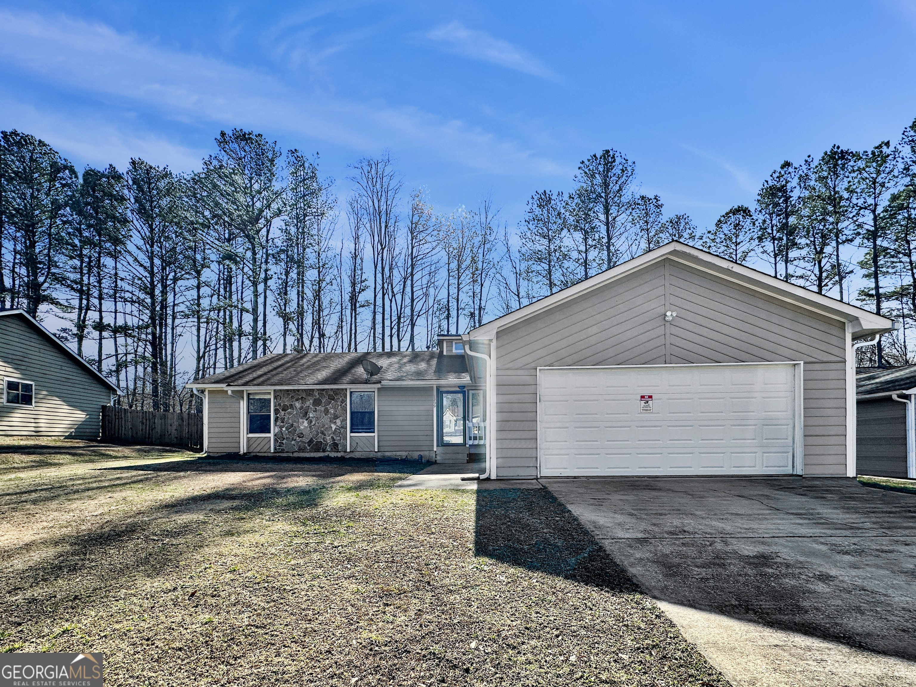 a front view of a house with a yard and trees