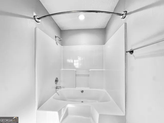 a bathroom with a bathtub and shower