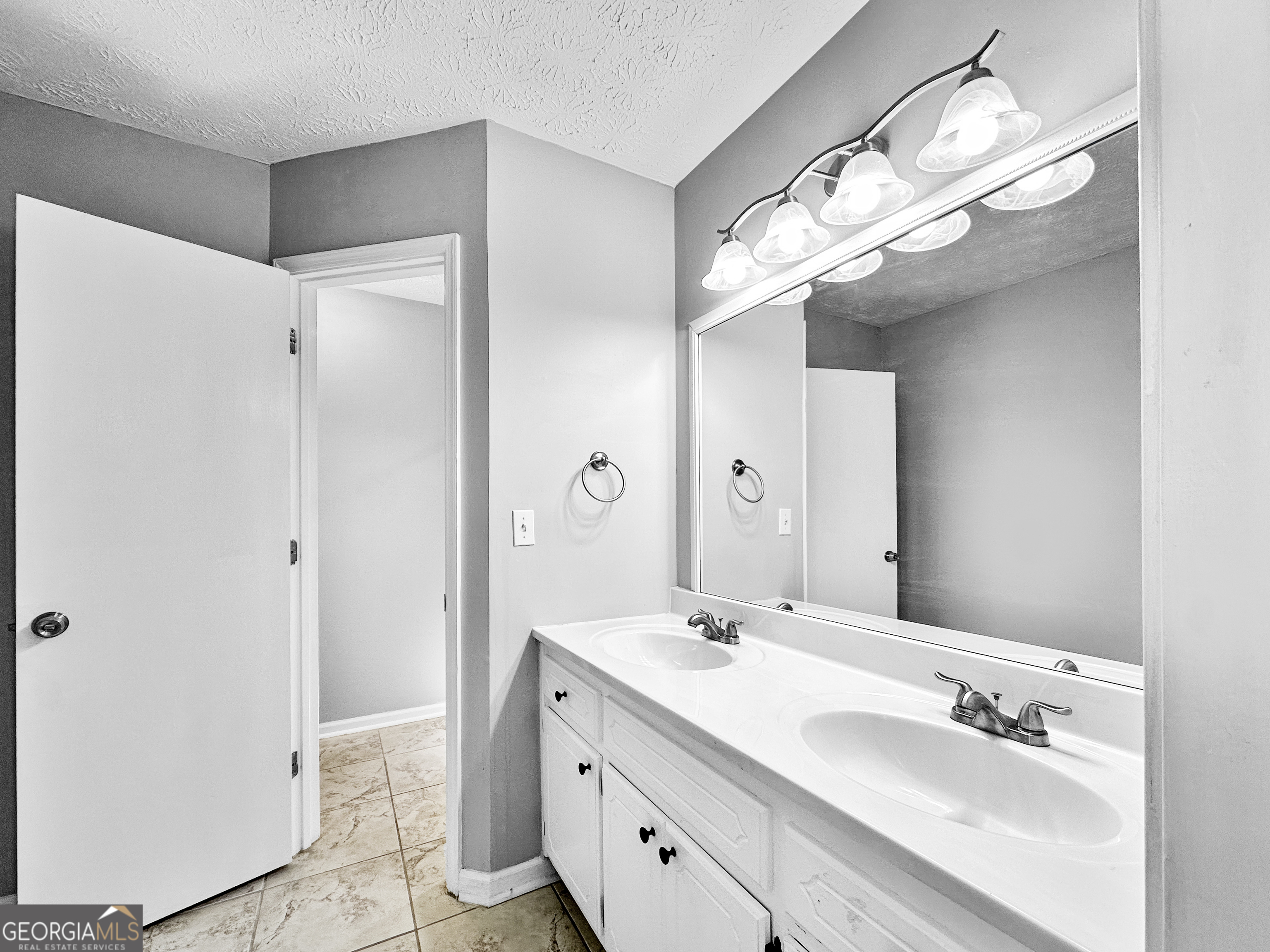 1299 Bugle Court Hampton, GA 30228 - Photo 12 of 18 a bathroom with a double vanity sink and a mirror