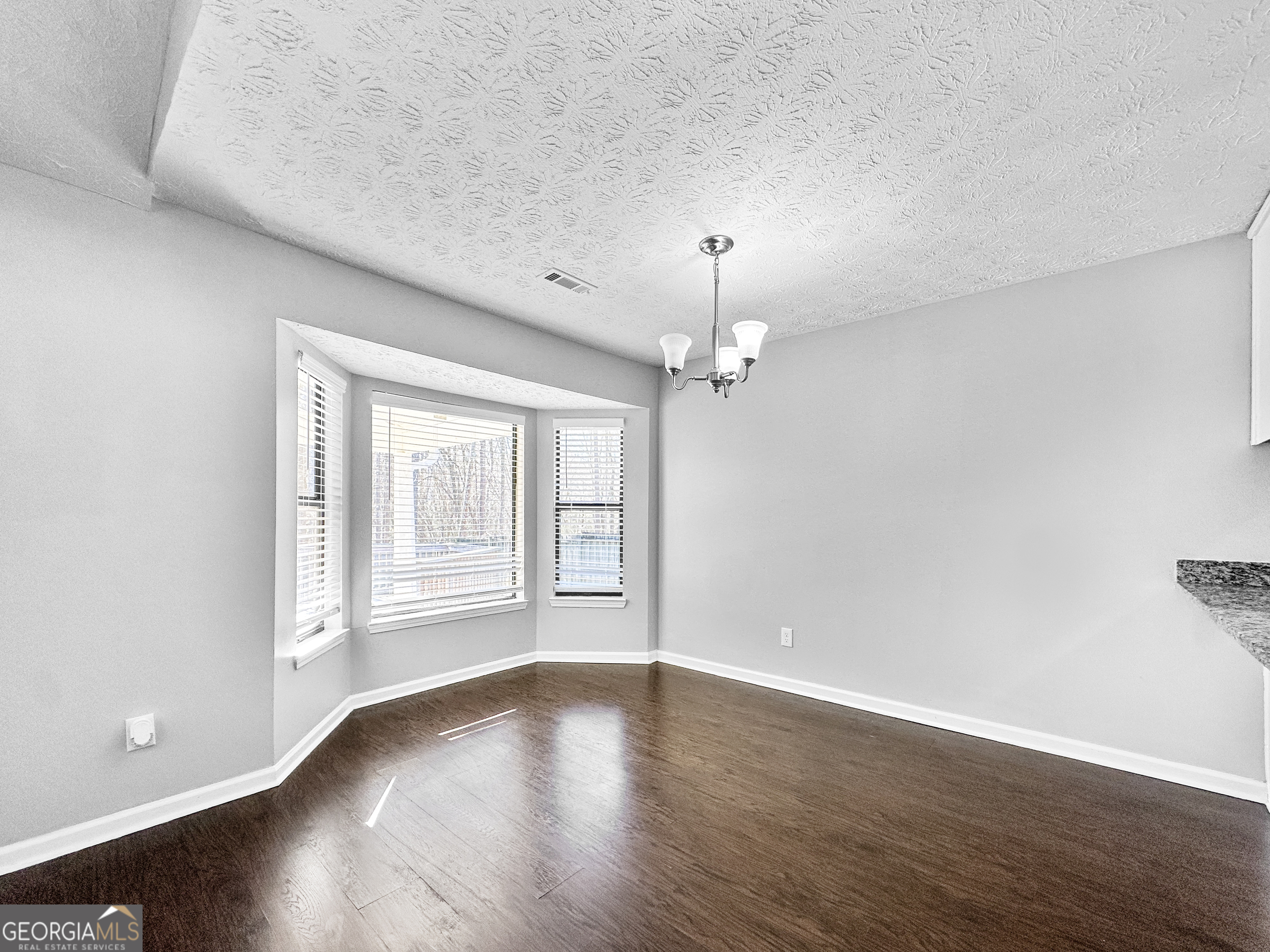 1299 Bugle Court Hampton, GA 30228 - Photo 5 of 18 a view of an empty room with wooden floor and a window