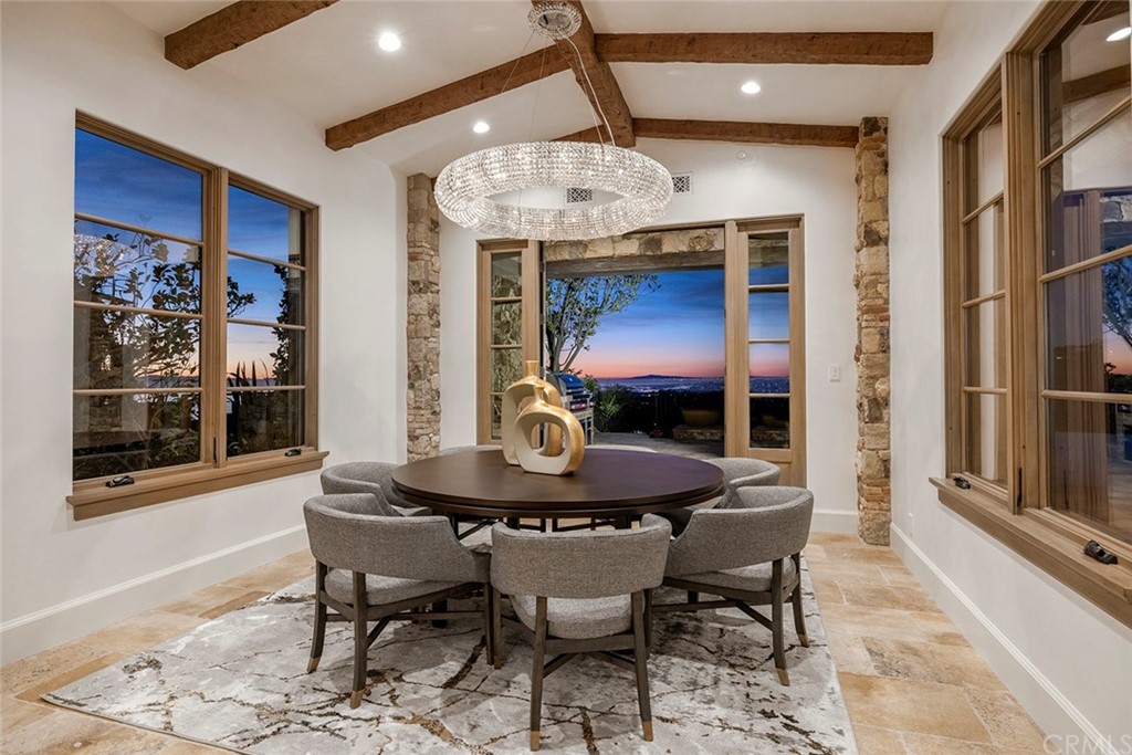 5 Clear Water Newport Coast, CA 92657 - Photo 12 of 41 a dining room with furniture a floor to ceiling window and wooden floor