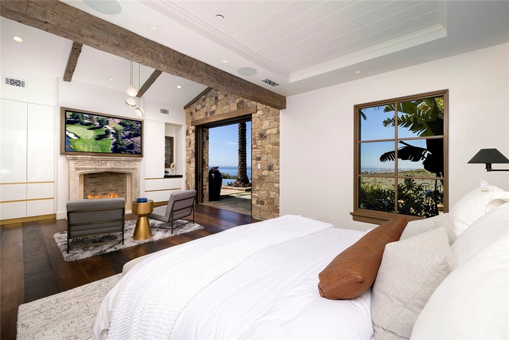 5 Clear Water Newport Coast, CA 92657 - Photo 20 of 41 a spacious bedroom with a bed and a fireplace