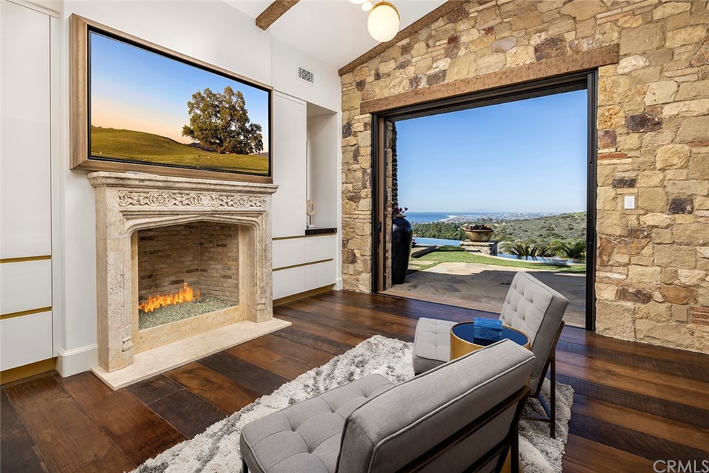 5 Clear Water Newport Coast, CA 92657 - Photo 21 of 41 a view of a livingroom with furniture a fireplace wooden floor and a fireplace