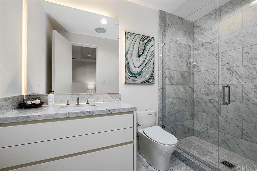5 Clear Water Newport Coast, CA 92657 - Photo 27 of 41 a bathroom with a granite countertop toilet sink and mirror