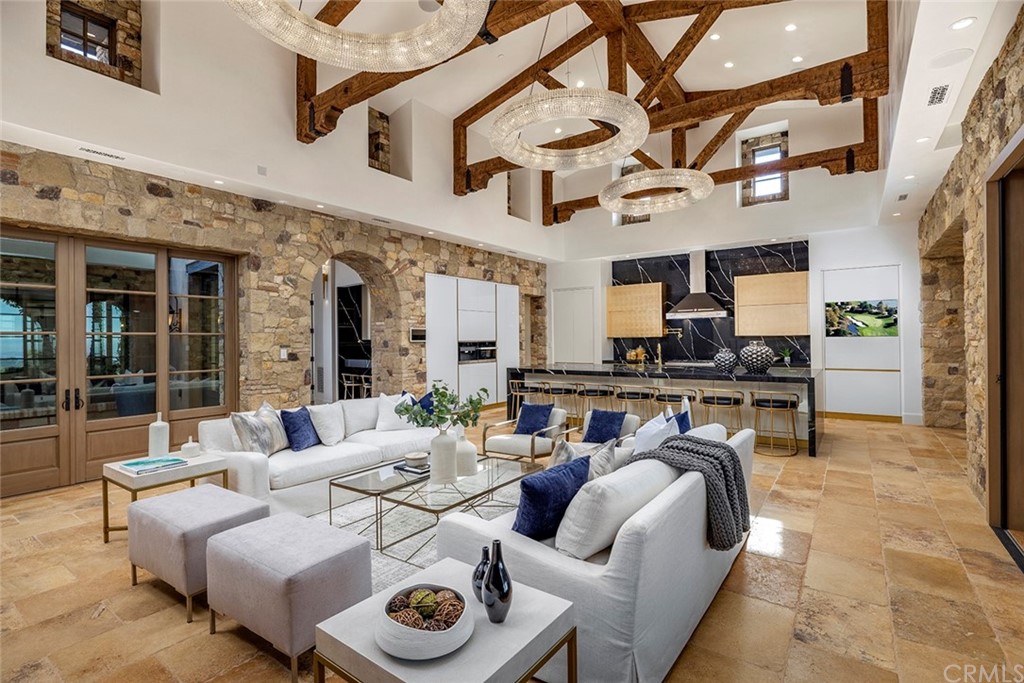 5 Clear Water Newport Coast, CA 92657 - Photo 4 of 41 a living room with furniture a fireplace and a ceiling fan