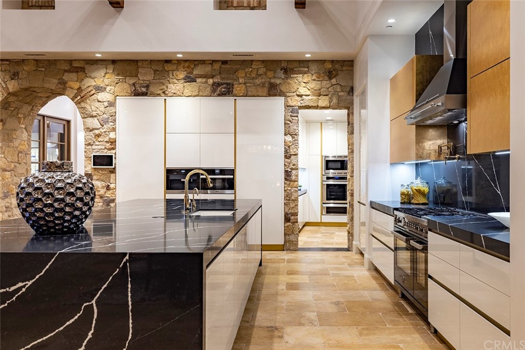 5 Clear Water Newport Coast, CA 92657 - Photo 8 of 41 a kitchen with kitchen island granite countertop a stove and a refrigerator