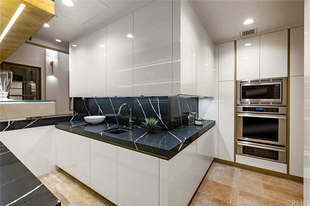 5 Clear Water Newport Coast, CA 92657 - Photo 10 of 41 a kitchen with stainless steel appliances granite countertop a sink and a microwave