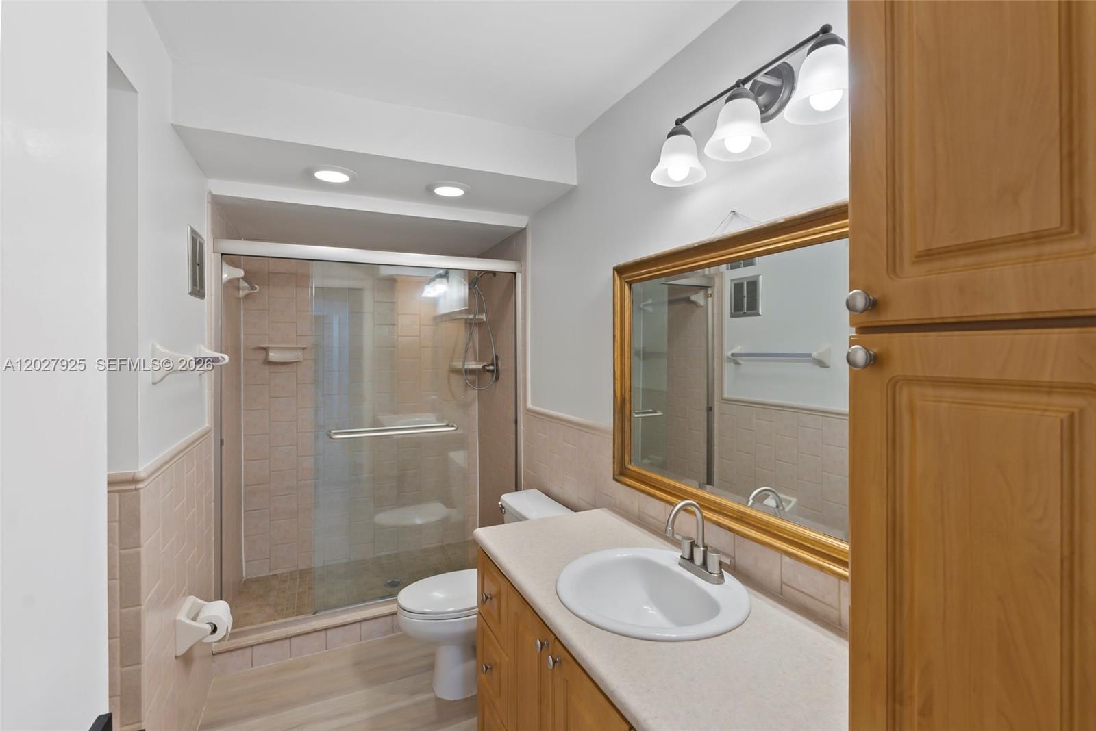 301 Racquet Club Road, Unit 103 Weston, FL 33326 - Photo 11 of 20 a bathroom with a sink a toilet and shower