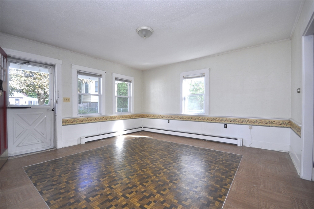 164 Warren Avenue Whitman, MA 02382 - Photo 14 of 34 an empty room with wooden floor and windows