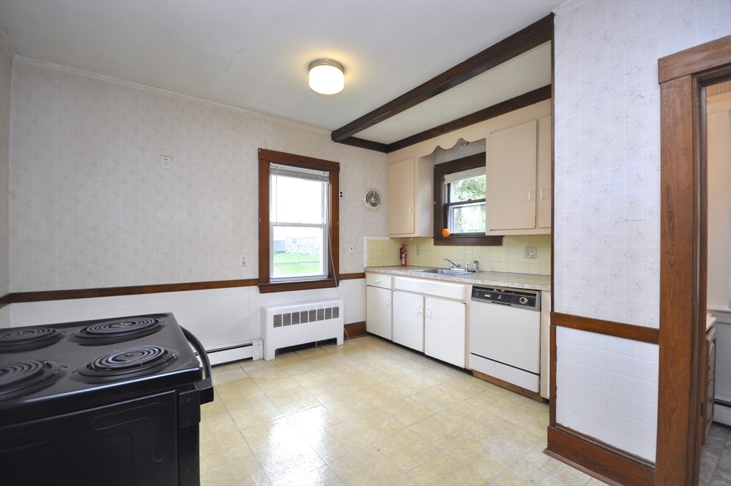 164 Warren Avenue Whitman, MA 02382 - Photo 16 of 34 a kitchen with granite countertop a stove and a refrigerator