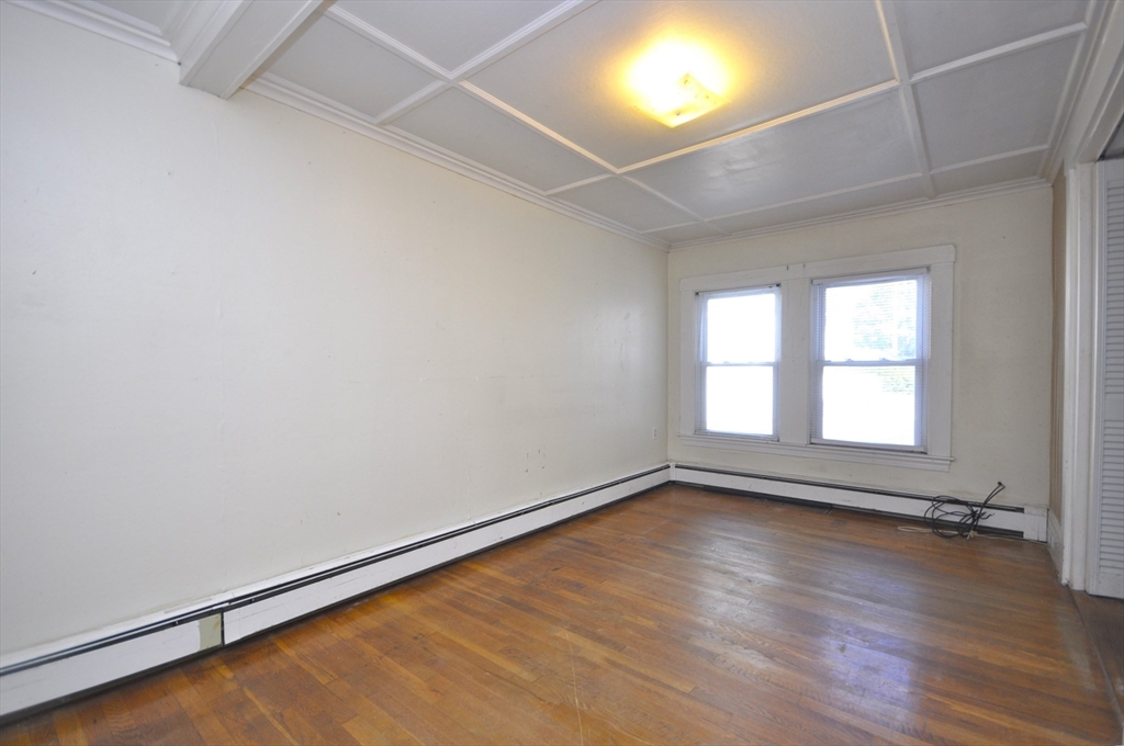 164 Warren Avenue Whitman, MA 02382 - Photo 18 of 34 an empty room with wooden floor and windows