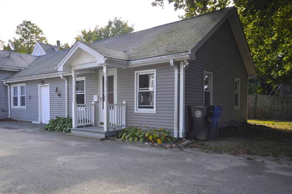 164 Warren Avenue Whitman, MA 02382 - Photo 19 of 34 a view of a brick house with many windows next to a road