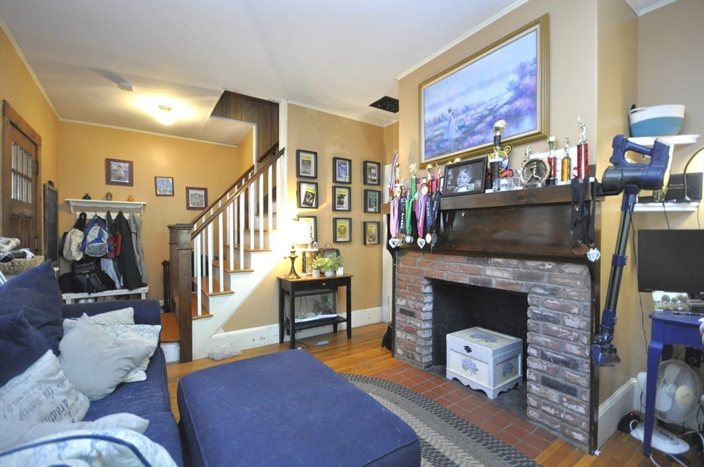 164 Warren Avenue Whitman, MA 02382 - Photo 6 of 34 a living room with furniture and a fireplace