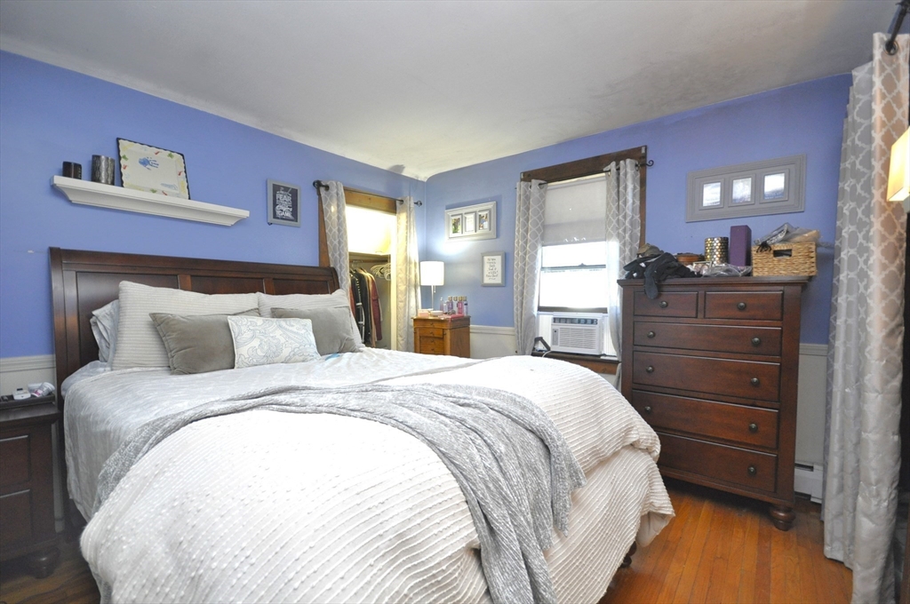 164 Warren Avenue Whitman, MA 02382 - Photo 8 of 34 a bedroom with a bed and a mirror