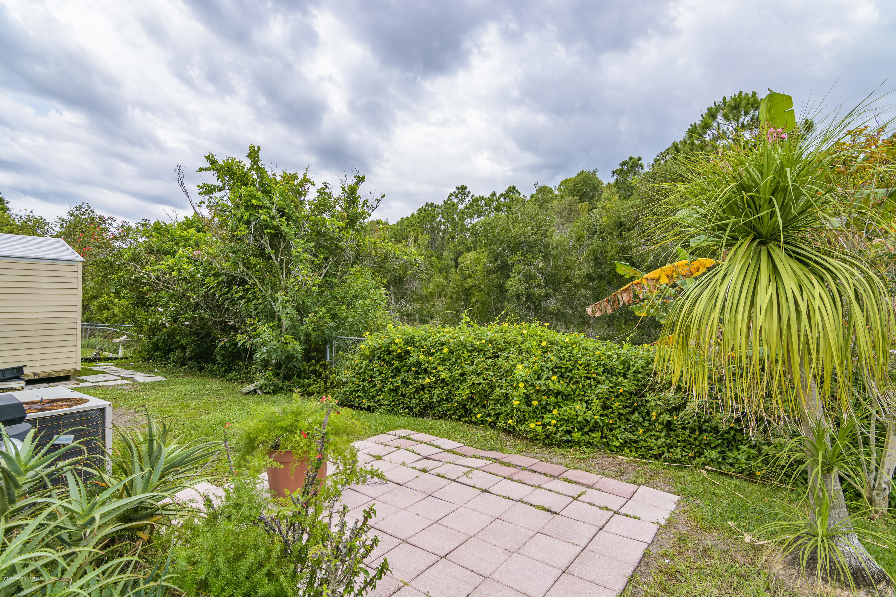 1818 Mango Street Northeast Palm Bay, FL 32905 - Photo 15 of 18 Side View To The Back Of Home