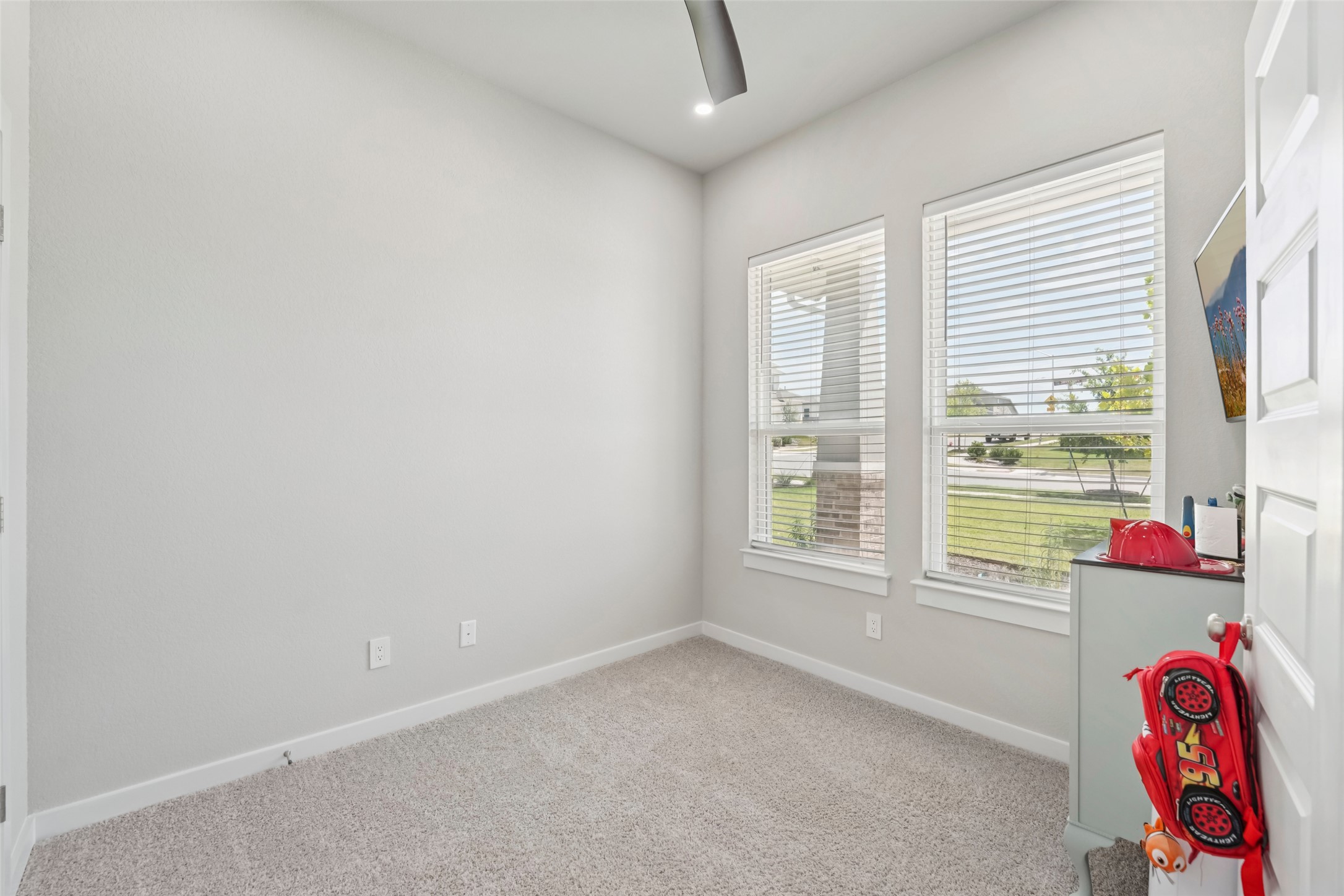 1108 Sweetspire Street Leander, TX 78641 - Photo 18 of 39 Carpeted spare room with a ceiling fan and recessed lighting