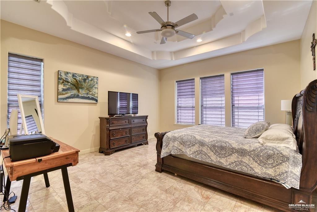2016 South 48th Street McAllen, TX 78503 - Photo 6 of 9 a bedroom with a bed and a couch