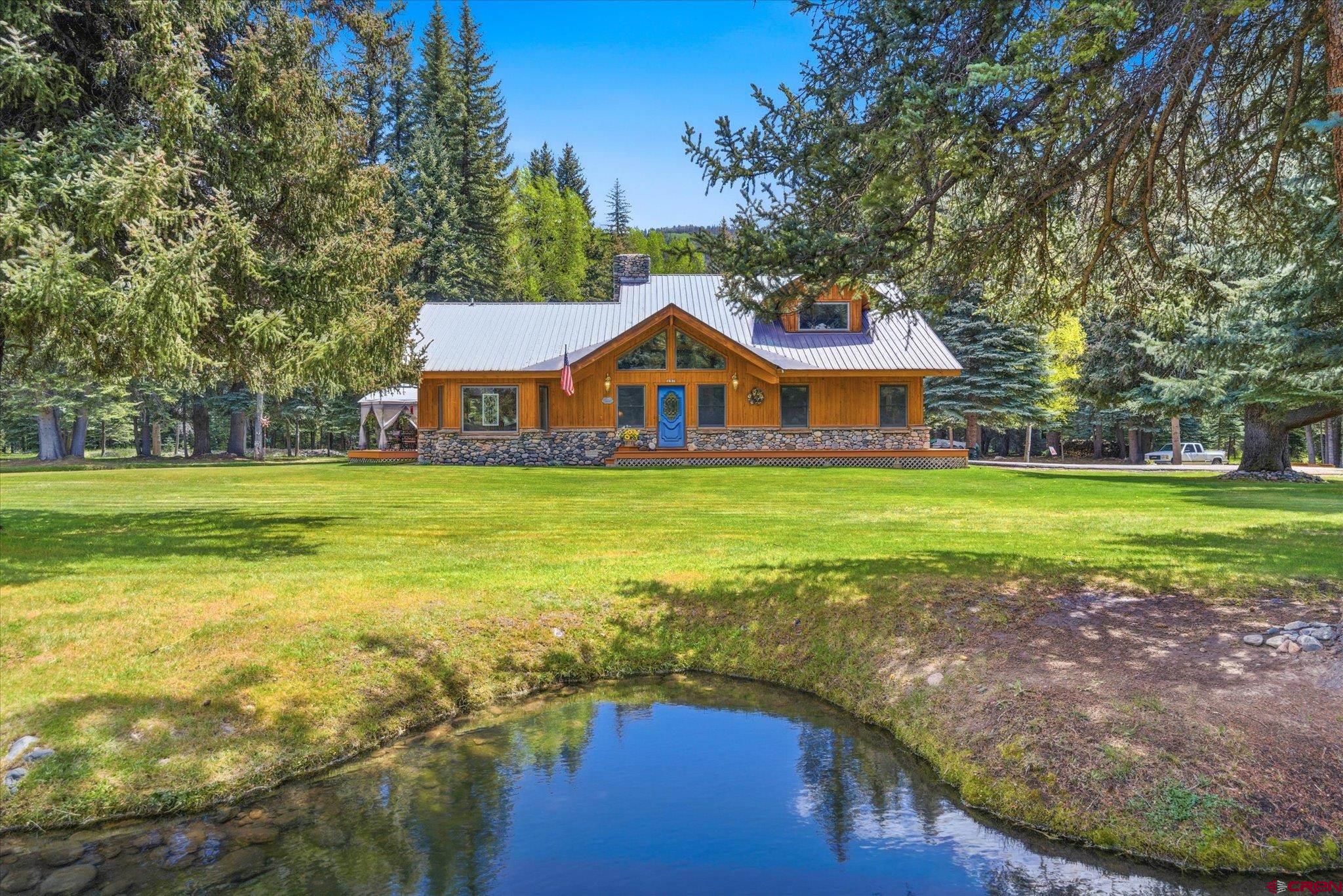 197 Hummingbird Way Bayfield, CO 81122 - Photo 2 of 44 a view of a house with a yard and sitting area