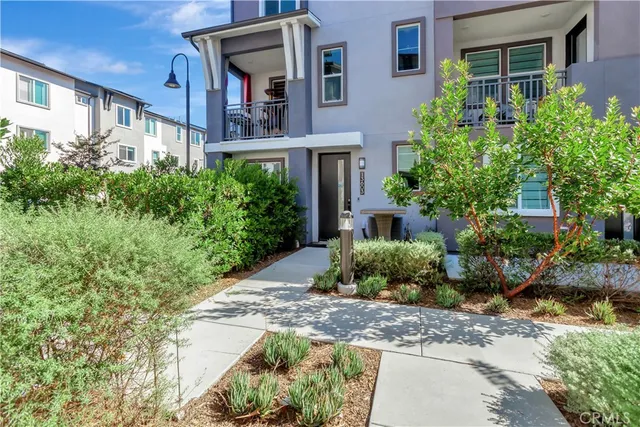 a kitchen with stainless steel appliances white cabinets a sink a stove a refrigerator and a microwave