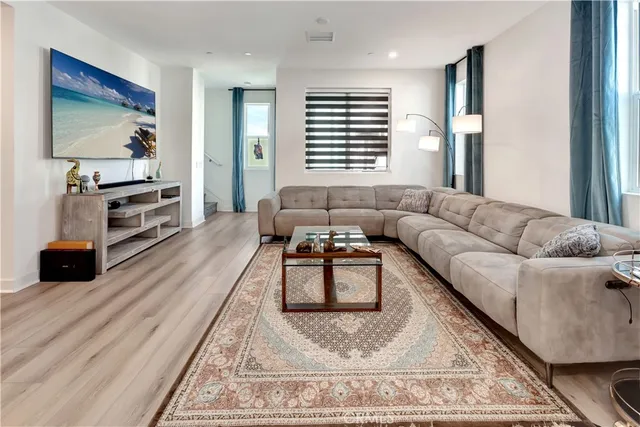 a kitchen with a refrigerator a stove top oven a sink dishwasher and a refrigerator with wooden floor