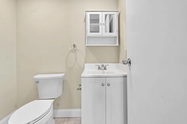 a white toilet sitting next to a bathroom sink