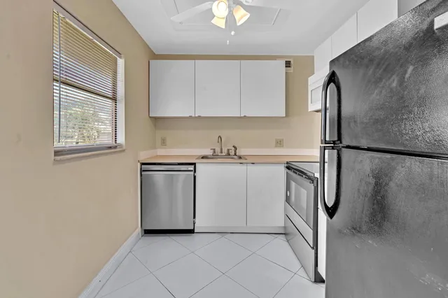 a utility room with cabinets washer and dryer