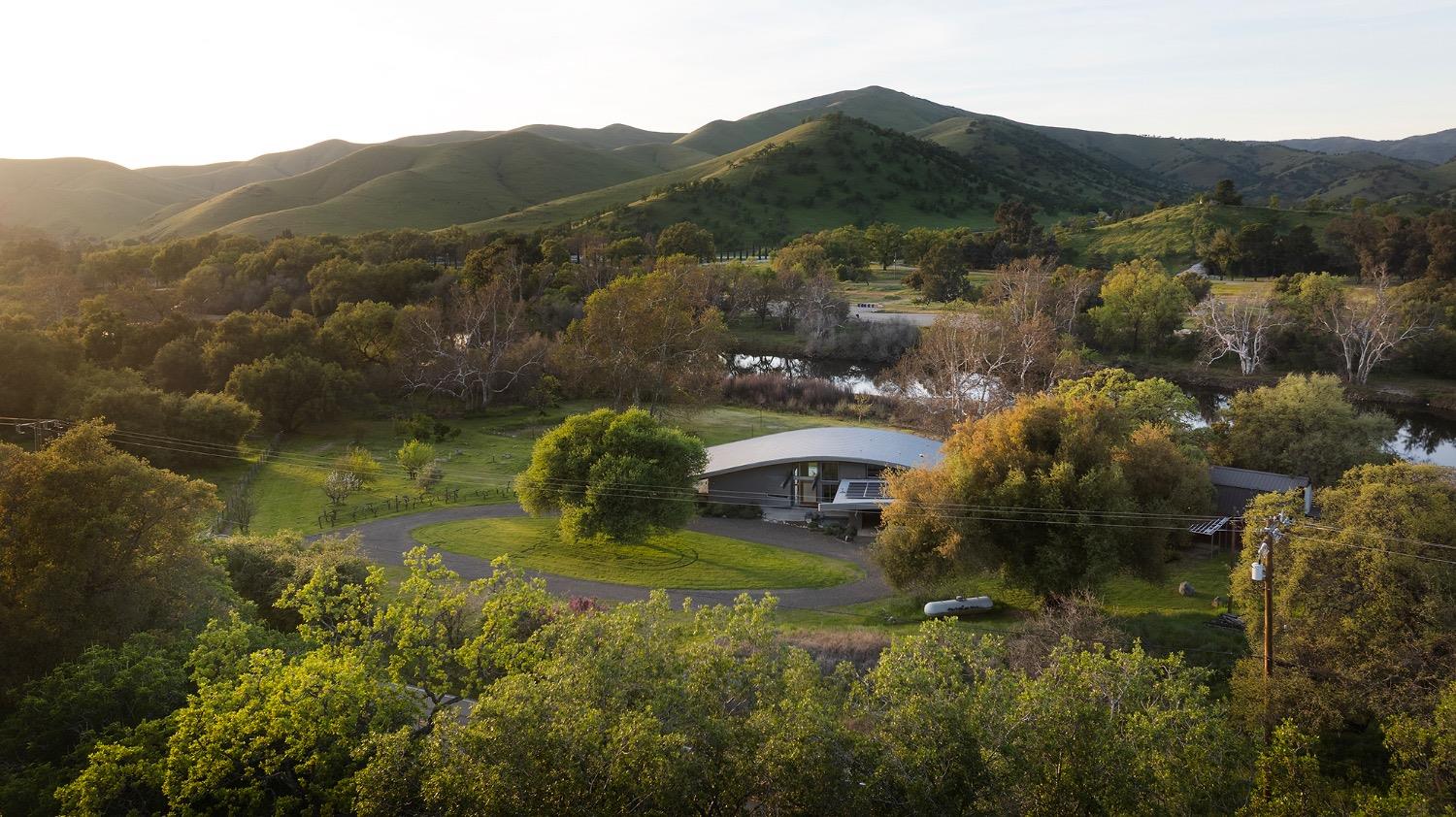 26210 Elwood Road Sanger, CA 93657 - Photo 5 of 36 a view of residential houses and lake with mountains in the back