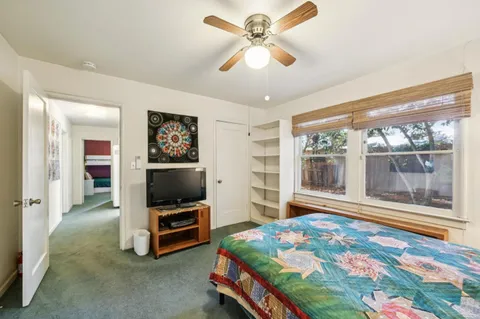 a bedroom with a bed and a television