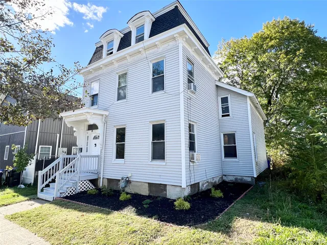a front view of a house with a yard