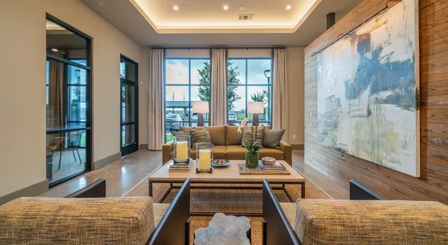 a dining hall with stainless steel appliances granite countertop a stove and a sink