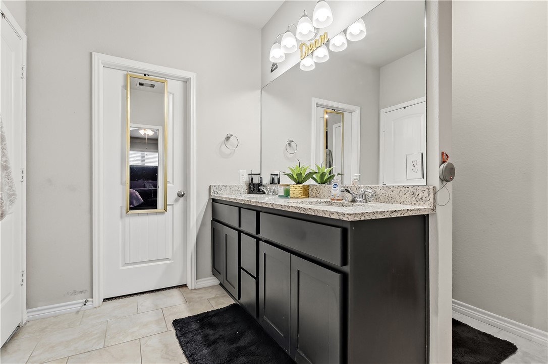 2009 Chief Street Bryan, TX 77807 - Photo 23 of 27 a bathroom with a double vanity sink and a mirror