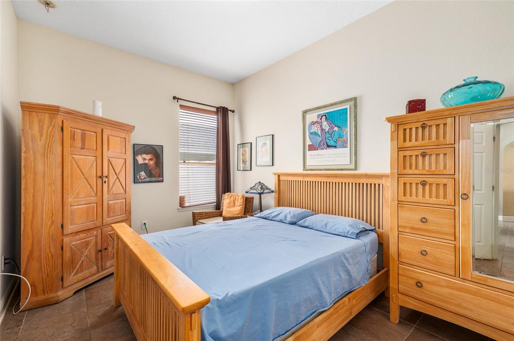 11845 Newberry Grove Loop Riverview, FL 33579 - Photo 27 of 47 a bedroom with a bed and a dresser