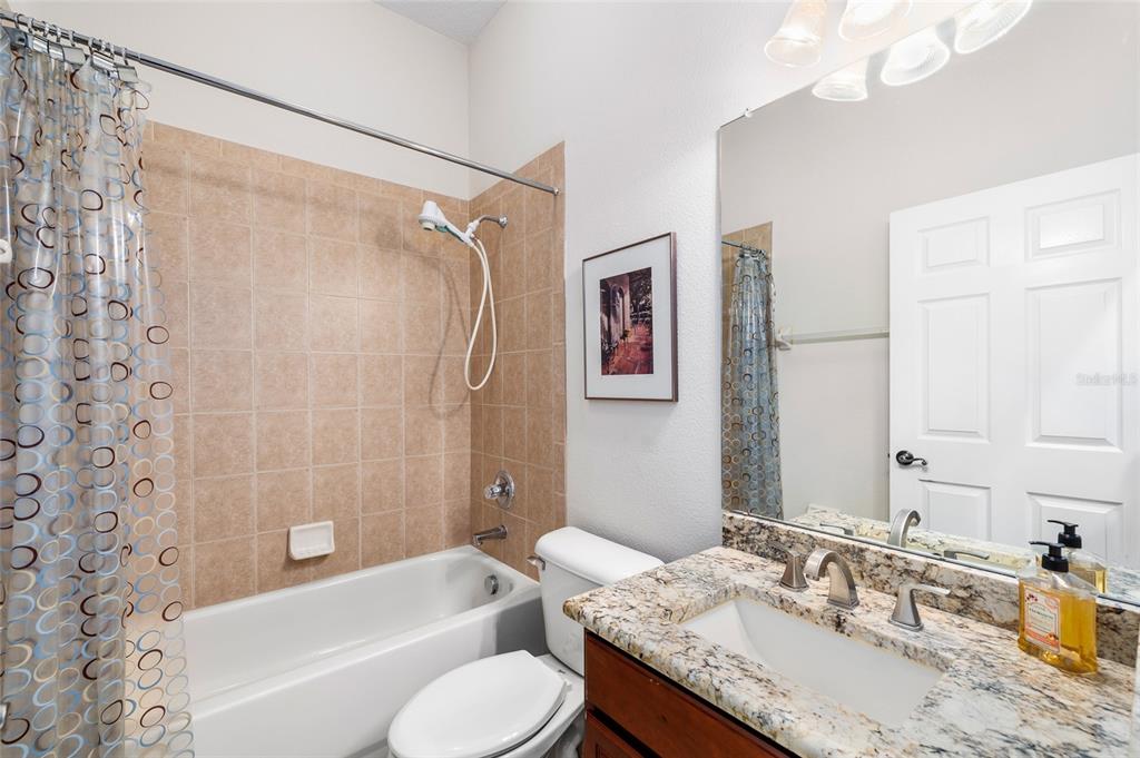 11845 Newberry Grove Loop Riverview, FL 33579 - Photo 28 of 47 a bathroom with a granite countertop sink toilet bathtub and shower