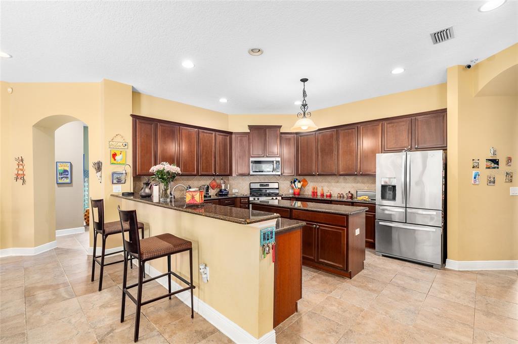 11845 Newberry Grove Loop Riverview, FL 33579 - Photo 6 of 47 a kitchen with refrigerator and cabinets