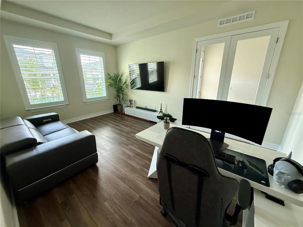 8441 Pk Clf Way Orlando, FL 32836 - Photo 6 of 59 a living room with furniture and a flat screen tv
